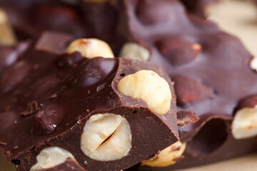 Pieces of homemade milk chocolate with lots of hazelnuts