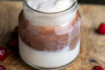 Yogurt with plum jam in a jar