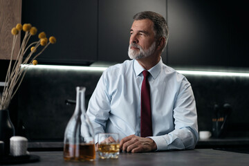 Confident rich mature wealthy businessman chilling relaxing drinking enjoying whiskey in the...