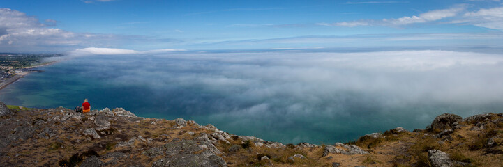 View from the summit of Bray Head with sea mist rolling over the coastline