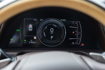 Glowing dashboard of a modern expensive car. The interior of the car. Modern luxury hybrid car...
