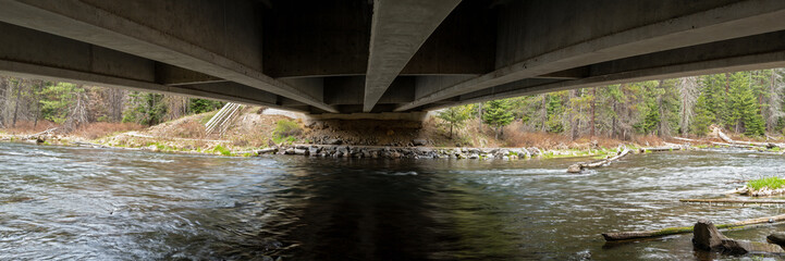 A panorama of the Deschutes River flowing under the Highway 42 bridge near LaPine, Oregon, USA