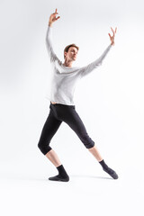 One Caucasian Handsome Young Man Dancing Ballet Posing with Lifted hands in White Shirt On White Background.