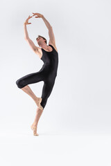 Professional Male Ballet Dancer Young Athletic Man in Black Suit Posing in Ballanced Dance Pose Studio