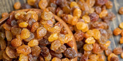 Dried yellow golden raisins on a board