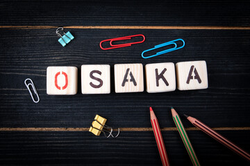 OSAKA. City name from alphabet letters on wood texture background