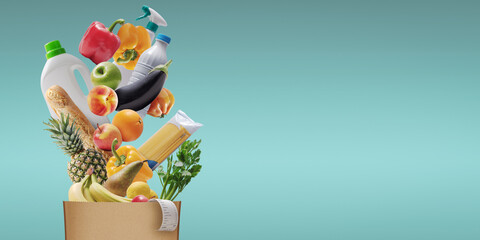 Assorted groceries falling in a paper bag