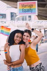 A lesbian couple shows off her homosexual identity in a pride parade.