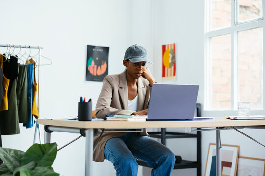 Young freelancer working on laptop at office