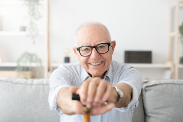 Happy positive elderly man smiling at camera