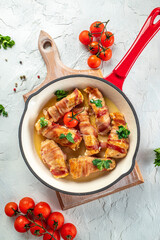 Baked chicken breast wrapped in bacon on a cast-iron frying pan. Concept healthy and balanced eating. place for text, top view