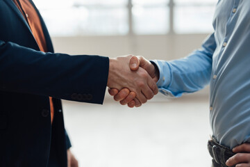 Businessman shaking hands with colleagues at industry