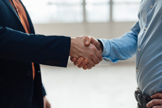 Businessman shaking hands with colleagues at industry