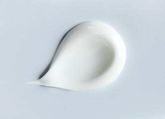cosmetic smears of creamy texture on gray background
