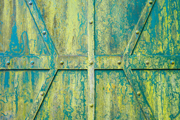Old green metal gate with rivets. Background. Industry.
