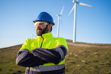 Smiling mature technical engineer with arms crossed