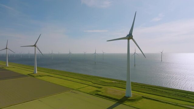 Group of Windmills on Land and Sea Generating Sustainable Energy near Urk, the Netherlands