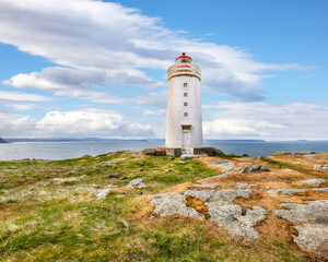 Fototapeta na wymiar Breathtaking view of Skarsviti lighthouse in Vatnsnes peninsula on a clear day in North Iceland.