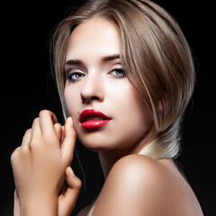 Fototapeta premium Portrait of young woman with beautiful professional makeup on dark background