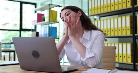 Worried puzzled woman looking at laptop in office and feeling stressed. Businesswoman frustrated due to problem with computer software