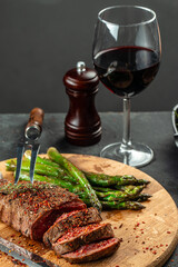 Barbecue steak with green asparagus and red wine. Healthy dinner or lunch. vertical image. top...