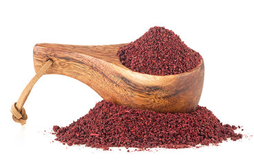 Ground sumac spice pile in wooden spoon isolated on a white background