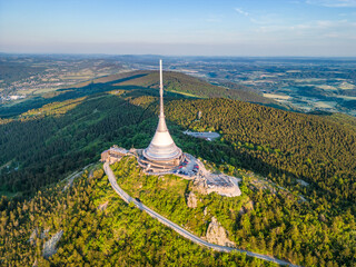 Sunny evening at Jested Mountain with unique building on the summit. Liberec, Czech Republic. Aerial view from drone.
