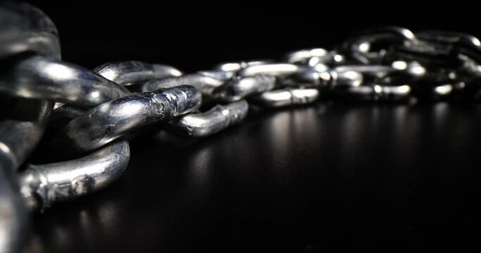 Chrome plated metal chain steel chain on black background. Metal links in a chain