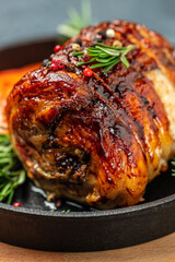 roast pork roulade Porchetta, delicious pork with cranberry berries on a dark background. Restaurant menu, dieting, cookbook recipe top view