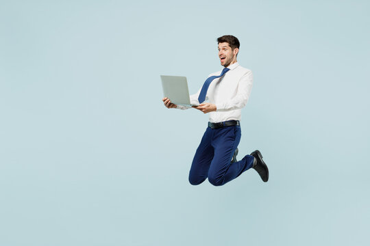 Full Body Fun Sideways Young Employee IT Business Man Corporate Lawyer In Classic Formal Shirt Tie Work In Office Hold Use Laptop Pc Computer Isolated On Plain Pastel Blue Background Studio Portrait