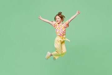 Full body happy little child kid girl 6-7 years old wear casual clothes jump high raise up hands...