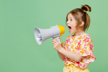 Little child kid girl 6-7 years old wear casual clothes hold in hand megaphone scream announces...