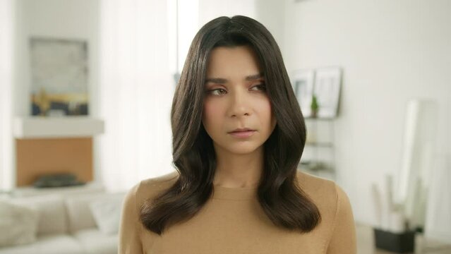 Thoughtful sad worried young woman looking away think of loneliness grief sorrow concept. Depressed young gorgeous house wife lost in thought feel concerned alone at home, close up portrait view 4K