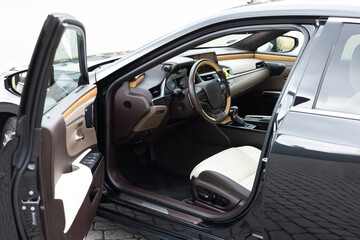 Plakat Modern luxury car Interior - steering wheel, shift lever and dashboard. Car interior luxury inside. Steering wheel, dashboard, speedometer, display. Brown leather interior. White leather interior