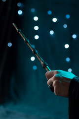 Fototapeta premium The magician's hand holds a magic elder wand
