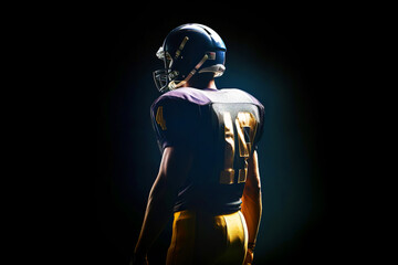 Fototapeta na wymiar American football player on dark background.