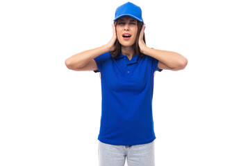 pretty surprised young woman in blue cotton t-shirt and cap with mockup isolated on white background with copy space