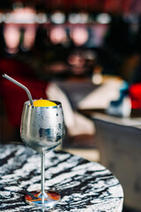 alcoholic cocktail in a glass stands on a table in a bar or restaurant