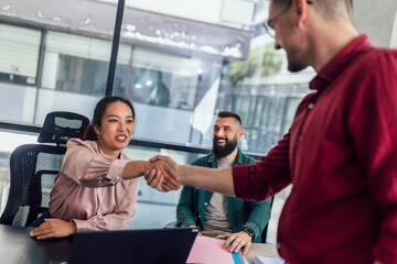Human resource team talking to a candidate during a job interview in the office.