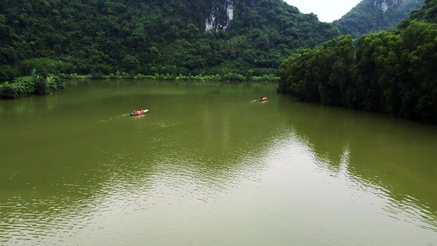 Drone Following Paddled Boats with Tourists in Ninh Binh Bird Park