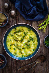 Asparagus soup on wooden table

