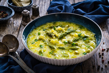 Asparagus soup on wooden table
