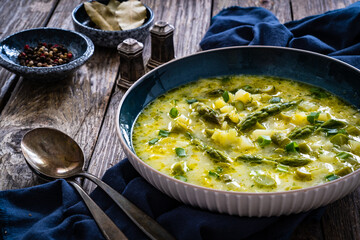 Asparagus soup on wooden table
