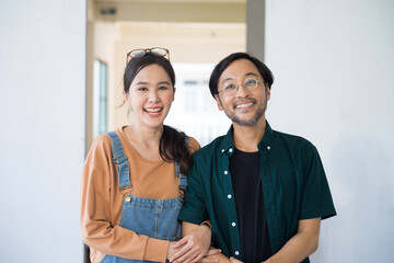 Portrait Asian couple looking at camera at home