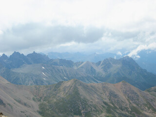 Aerial panoramic view of the Main Caucasus Mountain Ridge from Mount Elbrus, the highest summit in Europe, glacier Seven, incredible blue sky background, impressive nature landscape in North Caucasus