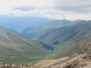 Aerial panoramic view of the Main Caucasus Mountain Ridge from Mount Elbrus, the highest summit in Europe, glacier Seven, incredible blue sky background, impressive nature landscape in North Caucasus