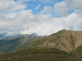 Aerial panoramic view of the Main Caucasus Mountain Ridge from Mount Elbrus, the highest summit in Europe, glacier Seven, incredible blue sky background, impressive nature landscape in North Caucasus
