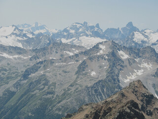Aerial panoramic view of the Main Caucasus Mountain Ridge from Mount Elbrus, the highest summit in Europe, glacier Seven, incredible blue sky background, impressive nature landscape in North Caucasus