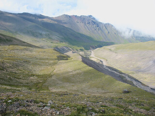 Aerial panoramic view of the Main Caucasus Mountain Ridge from Mount Elbrus, the highest summit in Europe, glacier Seven, incredible blue sky background, impressive nature landscape in North Caucasus