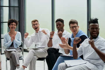 Business people with raised arms during seminar